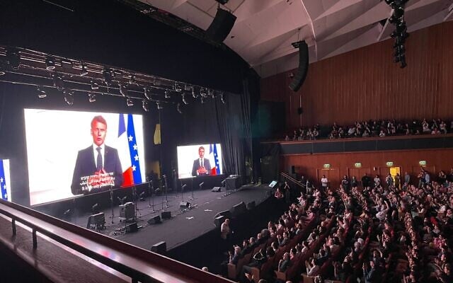 French President Emmanuel Macron sends a video message to the People’s Peace Summit at International Convention Center in Jerusalem on May 9, 2025. (Rossella Tercatin/Times of Israel)
