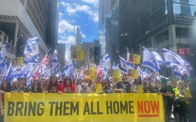 Released hostages and relatives of the Gaza hostages ride on a Hostages and Missing Families Forum float at the May 18, 2024, Israel Day parade in New York City (Jessica Steinberg/Times of Israel) Released hostages and relatives of the Gaza hostages ride on a Hostages and Missing Families Forum float at the May 18, 2024, Israel Day parade in New York City (Jessica Steinberg/Times of Israel)