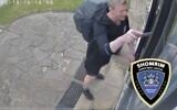 Screen capture of video showing a man using a knife to prise loose a mezuzah from a Jewish home in London, May 19, 2025. (X: Used in accordance with Clause 27a of the Copyright Law)