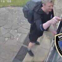 Screen capture of video showing a man using a knife to prise loose a mezuzah from a Jewish home in London, May 19, 2025. (X: Used in accordance with Clause 27a of the Copyright Law)