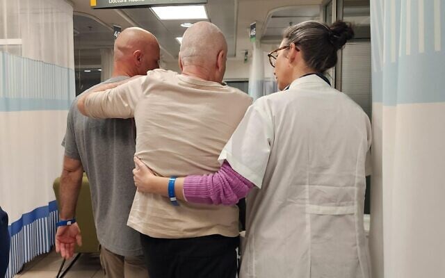 Dr. Noya Shilo, head of the Return to Life Center at Sheba Medical Center, walks with two hostages released from Gaza captivity in February 2024. (Courtesy/Sheba Medical Center)