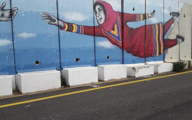 The "Talking Walls" border wall in Shtula, Israel, painted by Artists4Israel on May 26, 2023. (Lindy Barnett/Courtesy)