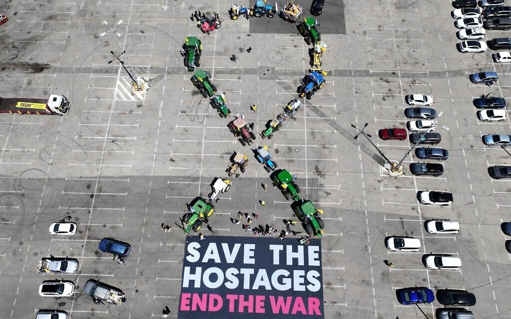 Kibbutz tractors make a shape of a hostage ribbon at a parking lot in Israel, May 31, 2025. (Yossi Yaron/Kibbutz Movement)