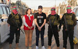 Freed hostage Edan Alexander with a representative of the Red Cross, flanked by Hamas gunmen in the Gaza Strip on May 12, 2025. (via Al Jazeera)