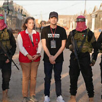 Freed hostage Edan Alexander with a representative of the Red Cross, flanked by Hamas gunmen in the Gaza Strip on May 12, 2025. (via Al Jazeera)