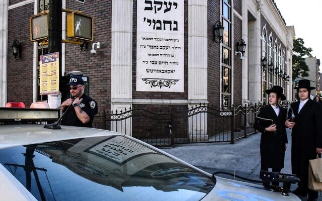 A member of the New York Police Department patrols in front of the synagogue Congregation Bais Yaakov Nechamia Dsatmar on October 13, 2023. (Stephanie Keith/Getty Images) A member of the New York Police Department patrols in front of the synagogue Congregation Bais Yaakov Nechamia Dsatmar on October 13, 2023. (Stephanie Keith/Getty Images)