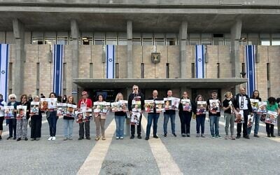 Family members and representatives of the 59 remaining hostages stand in front of the Knesset on May 5, 2025, to state that the Israeli public agrees that victory cannot be achieved without returning the hostages (Courtesy Hostages Family Forum)