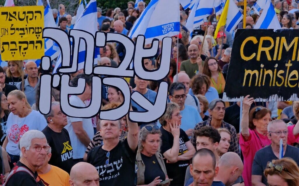 Anti-government protesters gather for a weekly rally at Habima Square, Tel Aviv, with a sign reading "strike now," May 10, 2025. (Adar Eyal/Pro-Democracy Protest Movement)