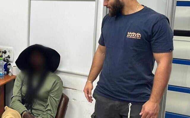 A British activist being questioned by police in a photo released on May 13, 2025. (Police spokesperson)