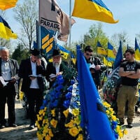 Rabbi Jonathan Markovitch, a Chabad emissary in Kyiv, celebrates the funeral of a Ukrainian Jewish soldier in June 2024. (Courtesy)