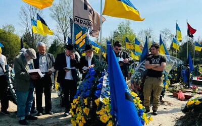 Rabbi Jonathan Markovitch, a Chabad emissary in Kyiv, celebrates the funeral of a Ukrainian Jewish soldier in June 2024. (Courtesy)