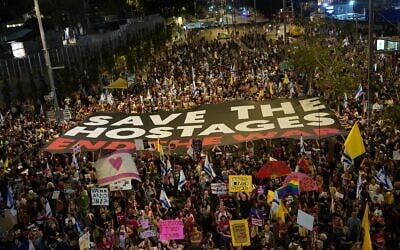 Protesters at Begin Road in Tel Aviv on May 24, 2025, carry a large banner, 'Save the Hostages End the War' (Credit: Dana Reany/Israeli Pro-Democracy Movement)