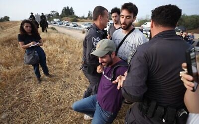 Prominent left-wing activist Alon-Lee Green is arrested by police during anti-war protest in Sderot, near the Gaza border on May 19, 2025. (Standing Together Movement/Courtesy)