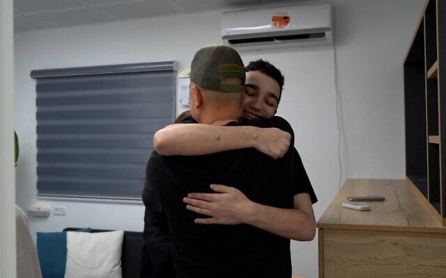 Released hostage Edan Alexander embraces his father Adi at an IDF base near Re'im, May 12, 2025. (Israel Defense Forces)
