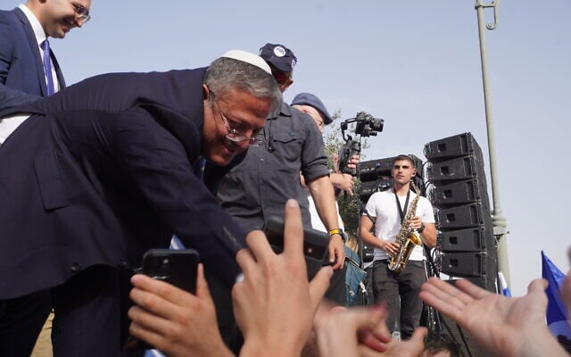 National Security Minister Itamar Ben Gvir high-fives religious Zionist revelers ahead of Jerusalem Day Flag March through the Old City on May 26, 2025. (Charlie Summers/Times of Israel)