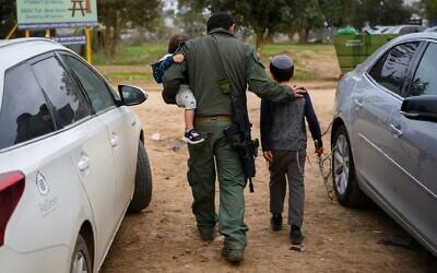Israeli children visit their reservist father in Southern Israel, December 17, 2023. (Alexi J. Rosenfeld/Getty Images via JTA)