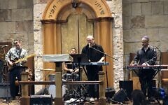 Lenny Solomon (singing) performs with Shlock Rock at the Young Israel of Oceanside synagogue in 2018 (Courtesy)