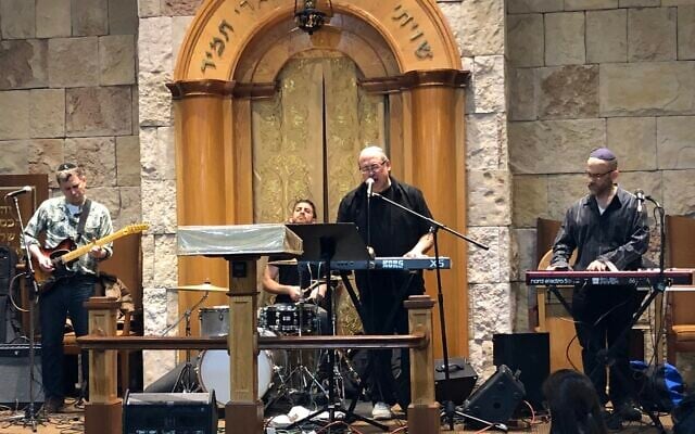 Lenny Solomon (singing) performs with Shlock Rock at the Young Israel of Oceanside synagogue in 2018 (Courtesy)
