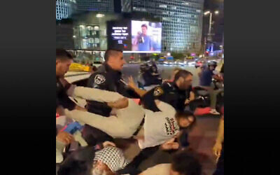 Anti-war activist Itamar Greenberg detained by police at a Tel Aviv demonstration on the evening of May 25, 2025. (Screenshot/X; used in accordance with Clause 27a of the Copyright Law)