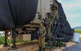 Troops of the newly established 946th Air Defense Battalion pose in front of an air defense system in northern Israel, May 6, 2025. (Israel Defense Forces)