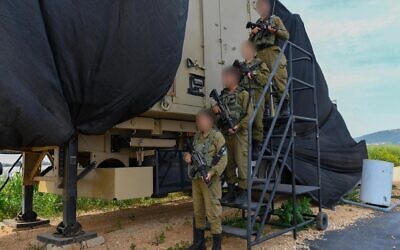 Troops of the newly established 947th Air Defense Battalion pose in front of an air defense system in northern Israel, May 6, 2025. (Israel Defense Forces)