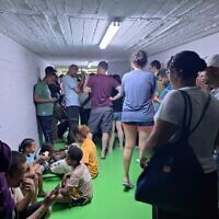 Israelis in a bomb shelter during an Iranian missile barrage that triggered sirens throughout Israel on June 20, 2025. (Ben Suissa / Times of Israel)