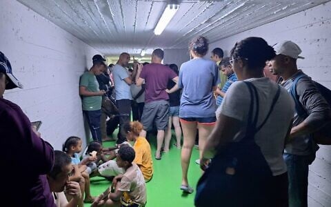 Israelis in a bomb shelter during an Iranian missile barrage that triggered sirens throughout Israel on June 20, 2025. (Ben Suissa / Times of Israel)