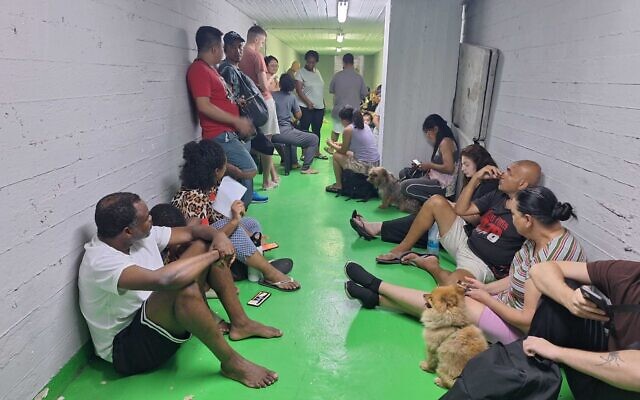 Israelis sit in a bomb shelter in Tel Aviv amid a barrage of rockets from Iran on June 22, 2025 (Times of Israel)