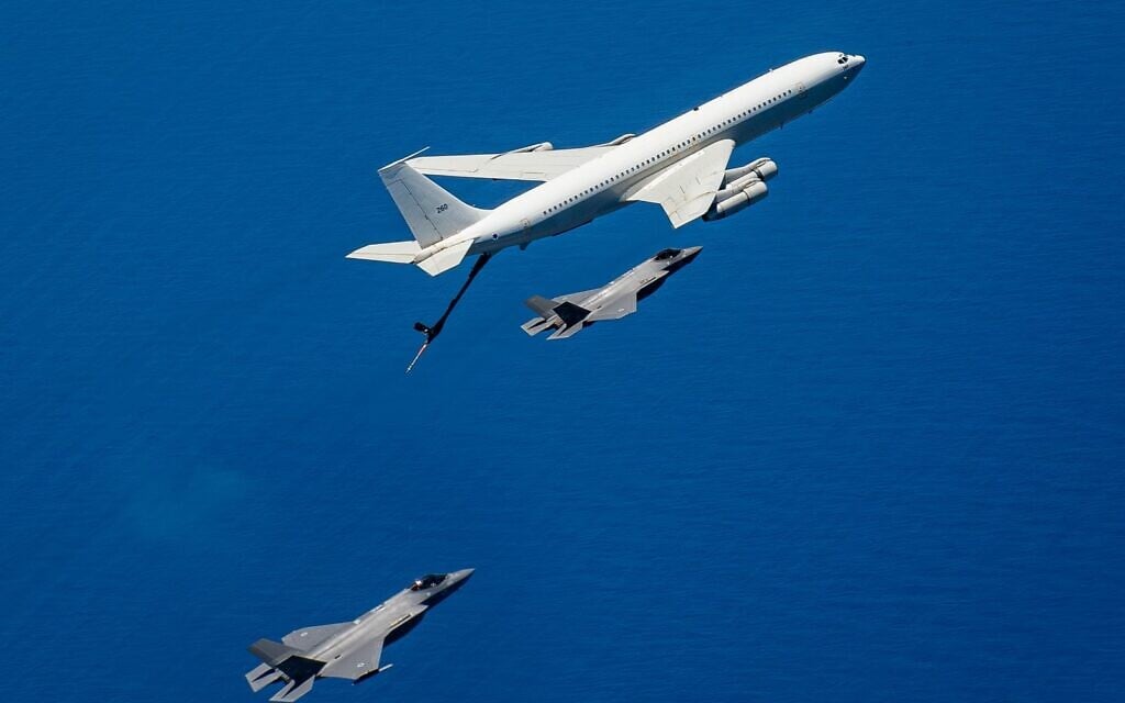 An IAF Boeing 707 refueling plane flies alongside F-35 fighter jets over the Middle East, in a handout photo issued on June 18, 2025. (Israel Defense Forces)