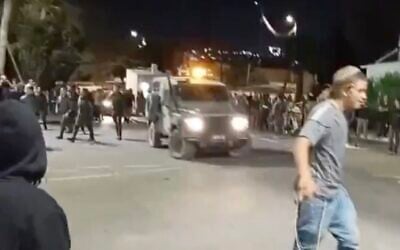 Settlers riot outside the Binyamin Regional Brigade military base in the West Bank, June 29, 2025. (X screenshot)