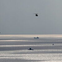 A handout picture provided by the Iranian Army office on December 31, 2022, shows Iranian troops during a military drill in Makran beach on the Gulf of Oman, near the Hormuz Strait. (Iranian Army office / AFP)