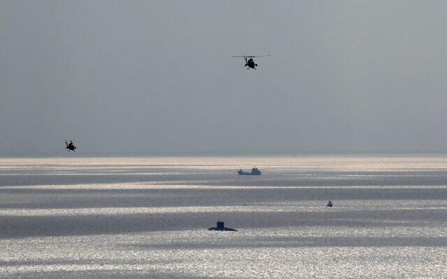 A handout picture provided by the Iranian Army office on December 31, 2022, shows Iranian troops during a military drill in Makran beach on the Gulf of Oman, near the Hormuz Strait. (Iranian Army office / AFP)