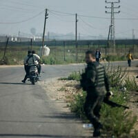 Hamas terrorists move towards the Erez crossing between Israel and the northern Gaza Strip, during the terror group's onslaught on October 7, 2023.  (Mohammed ABED / AFP)