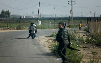 Hamas terrorists move towards the Erez crossing between Israel and the northern Gaza Strip, during the terror group's onslaught on October 7, 2023.  (Mohammed ABED / AFP)