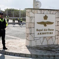 Police officers stand guard at the gates of the Royal Air Force Akrotiri base, a British overseas territory near the Cypriot coastal city of Limassol on January 14, 2024. (Iakovos Hatzistavrou / AFP)