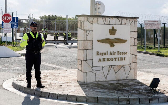 Police officers stand guard at the gates of the Royal Air Force Akrotiri base, a British overseas territory near the Cypriot coastal city of Limassol on January 14, 2024. (Iakovos Hatzistavrou / AFP)
