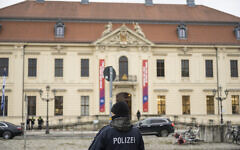 A police officer is pictured in front of the Jewish Museum Berlin building in Berlin, Germany on February 8, 2024. (Stefanie Loos/AFP)