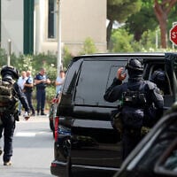 Illustrative: French law enforcement officers stand in front of a synagogue after two cars, one containing a gas bottle, were set alight in the area that morning, causing an explosion that injured a local policeman, La Grande-Motte, south of France, on August 24, 2024. (Pascal GUYOT / AFP)