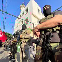 Armed and masked men attend the funeral of two operatives from the Popular Front for the Liberation of Palestine (PFLP), reportedly killed in southern Lebanon in fighting with Israel, in the Ain el Helweh refugee camp on November 1, 2024. (Mahmoud ZAYYAT / AFP)