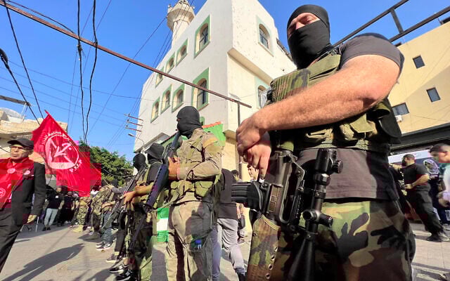 Armed and masked men attend the funeral of two operatives from the Popular Front for the Liberation of Palestine (PFLP), reportedly killed in southern Lebanon in fighting with Israel, in the Ain el Helweh refugee camp on November 1, 2024. (Mahmoud ZAYYAT / AFP) Armed and masked men attend the funeral of two operatives from the Popular Front for the Liberation of Palestine (PFLP), reportedly killed in southern Lebanon in fighting with Israel, in the Ain el Helweh refugee camp on November 1, 2024. (Mahmoud ZAYYAT / AFP)