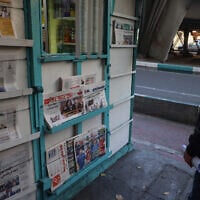 Illustrative: An Iranian man looks at newspapers displayed outside a kiosk in Tehran on November 6, 2024. (ATTA KENARE / AFP)