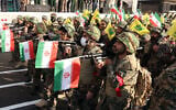 Members of Iranian paramilitary forces (Basij) march with weapons and their national flag during a rally in Tehran, January 10, 2025. (AFP)