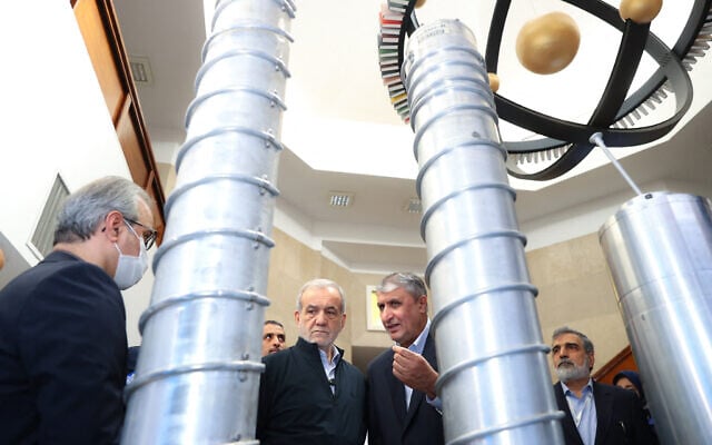 A handout picture provided by the Iranian presidency shows President Masoud Pezeshkian, second left, and the Atomic Energy Organization of Iran chief Mohammad Eslami, second right, during the 'National Day of Nuclear Technology,' in Tehran, on April 9, 2025. (Iranian Presidency / AFP) A handout picture provided by the Iranian presidency shows President Masoud Pezeshkian, second left, and the Atomic Energy Organization of Iran chief Mohammad Eslami, second right, during the 'National Day of Nuclear Technology,' in Tehran, on April 9, 2025. (Iranian Presidency / AFP)