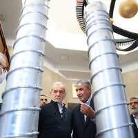 A handout picture provided by the Iranian presidency shows President Masoud Pezeshkian, second left, and the Atomic Energy Organization of Iran chief Mohammad Eslami, second right, during the 'National Day of Nuclear Technology,' in Tehran, on April 9, 2025. (Iranian Presidency / AFP)