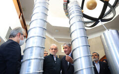 A handout picture provided by the Iranian presidency shows President Masoud Pezeshkian, second left, and the Atomic Energy Organization of Iran chief Mohammad Eslami, second right, during the 'National Day of Nuclear Technology,' in Tehran, on April 9, 2025. (Iranian Presidency / AFP)