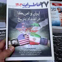 This picture shows a magazine front page at a kiosk in Tehran on April 19, 2025, featuring the Iran-US talks on the Iranian nuclear program set to begin in Rome on the same day. (Photo by ATTA KENARE / AFP)
