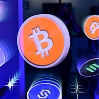Illustrative: Logos of Bitcoin and different cryptocurrencies are displayed during the Token2049 conference at the Token2049 conference in Dubai on May 1, 2025. (Giuseppe CACACE / AFP)