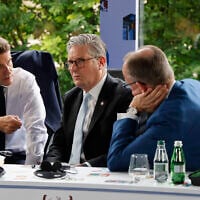 Left to right: France's President Emmanuel Macron, Britain's Prime Minister Keir Starmer and Germany's Chancellor Friedrich Merz take part in a meeting during the European Political Community (EPC) summit, in Tirana, Albania, on May 16, 2025. (Photo by Ludovic MARIN / AFP)