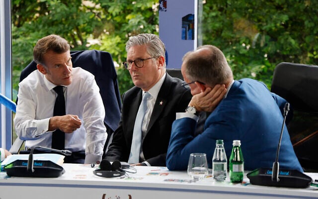 Left to right: France's President Emmanuel Macron, Britain's Prime Minister Keir Starmer and Germany's Chancellor Friedrich Merz take part in a meeting during the European Political Community (EPC) summit, in Tirana, Albania, on May 16, 2025. (Photo by Ludovic MARIN / AFP)