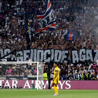 Fans hold a giant banner reading 'Stop genocide in Gaza' during the UEFA Champions League final soccer match between Paris Saint-Germain (PSG) and Inter Milan in Munich, southern Germany, on May 31, 2025. (Odd Andersen / AFP)